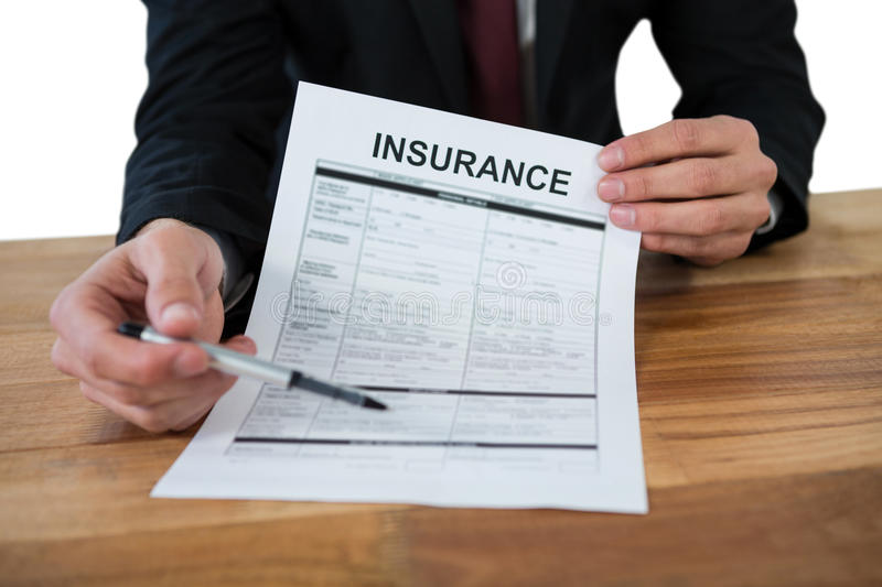mid section businessman sitting desk holding insurance contract white background 78722301 - The First Two Power Packed Riders Insurance Plan In Malaysia